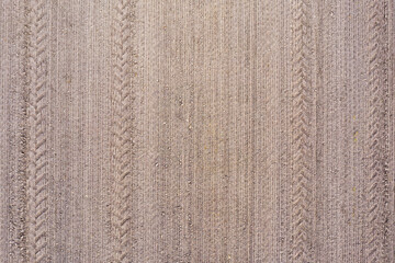 cereal field with tractor tire tracks, top down view, agricultural pattern