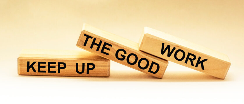 Keep up the good work, text is written on wooden blocks