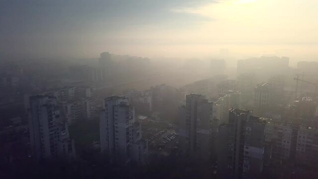 Flying over a concrete living apartment area in east Europa with many birds flying around the drone
