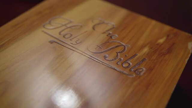 Close up of wooden book box labeled The Holy Bible