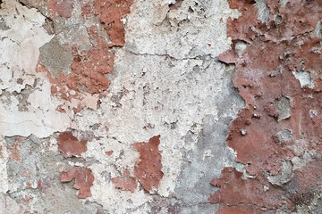 Old peeling plaster texture. White-gray brown cement wall. Damaged wall texture.