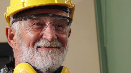 Senior factory worker or engineer close up portrait in factory . Industry and engineering concept .