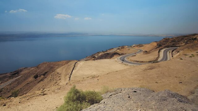 Dead Sea panorama road, Jordan. Wide long shot from the dead sea panorama with a car driving up. 4K