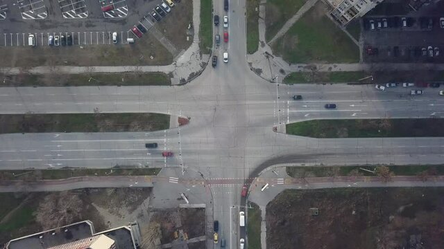 Flying over a concrete living apartment area in east Europa with many birds flying around the drone