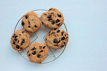 Fresh baked chocolate chip cookies on white background. View from above. Copy space. Selective focus
