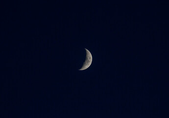 Nice young half moon on dark blue sky at evening © Serhii