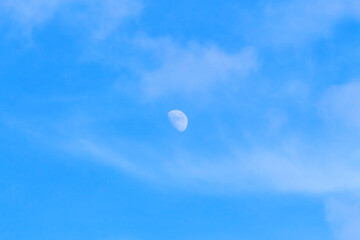 
Half moon on blue sky