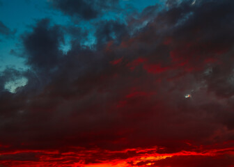 Beautiful sunset. Red and black clouds in the sky