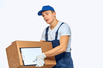 Fototapeta na wymiar Man worker with box in hands delivery loading service work light background