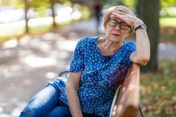 Senior woman suffering from a headache 
