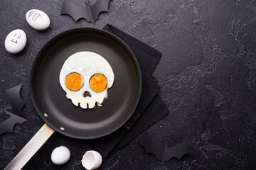 Fried eggs in the shape of a skull. Halloween breakfast.