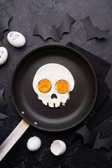 Fried eggs in the shape of a skull. Halloween breakfast.