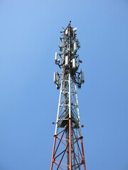 high cell tower against the blue sky