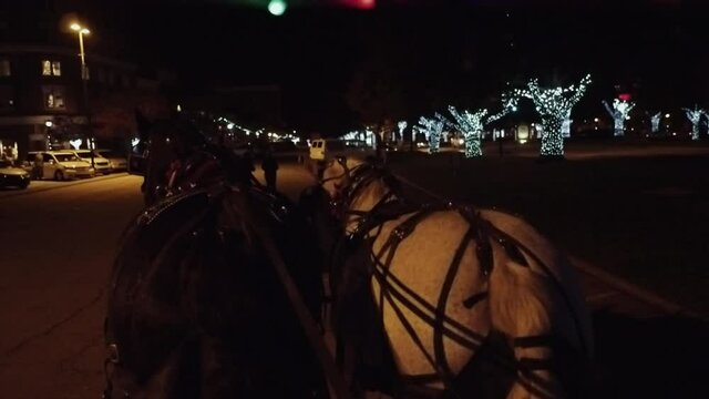 Horse Drawn Wagon Ride at Christmas in a Small Town Shopping District