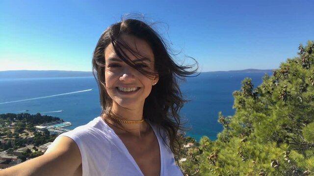Beautiful smiling young woman model taking selfie in Split, Dalmatia, Croatia from Marjan hill top
