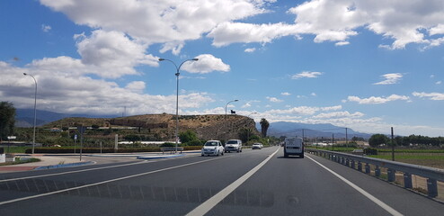 Fototapeta na wymiar road, highway, sky, travel, asphalt, car, traffic, way, transportation, landscape, motorway, clouds, horizon, line, driving, speed, blue, transport, cloud, route, freeway, drive, nature, journey, stre