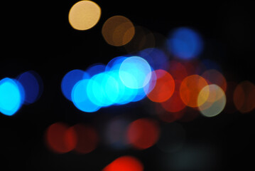 Bokeh traffic light at night in the street of a big city