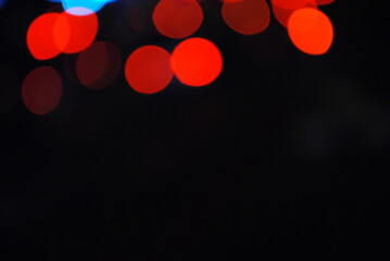 Bokeh traffic light at night in the street of a big city