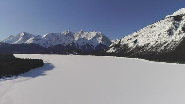 arial footage in the mountains of a frozen lake