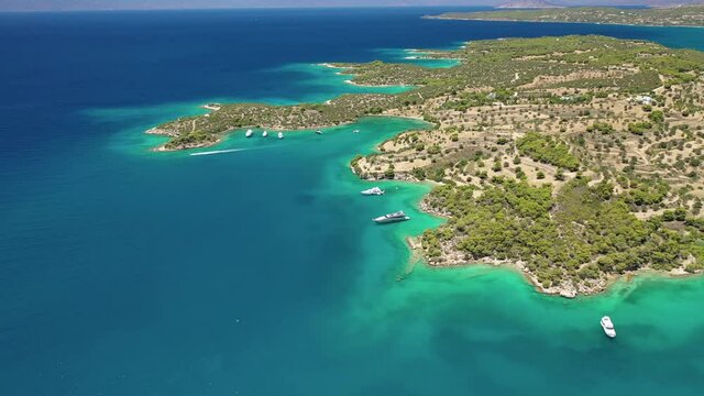 Aerial drone video of famous and picturesque yacht dock seaside fjord village of Porto Heli with turquoise and emerald clear waters, Argolida, Peloponnese, Greece