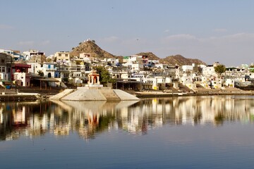 Fototapeta na wymiar Pushkar White Houses reflected into the lake, Rajasthan, India 
