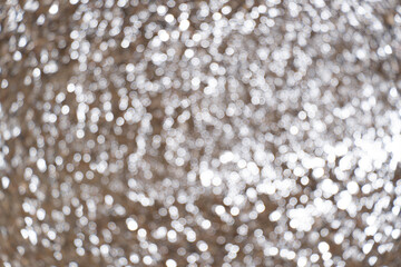 Twinkle wet beach sand. Brown and white bokeh of sand water and sun light. Texture, background and pattern