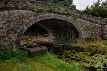 Fototapeta na wymiar Old Bridge at Foggy Canal