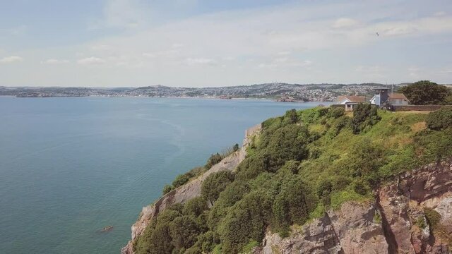 Zooming out of beautiful coastal landscape in Torquay, England.