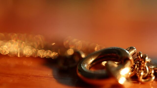 Jewel necklace sitting on a table in the sunlight