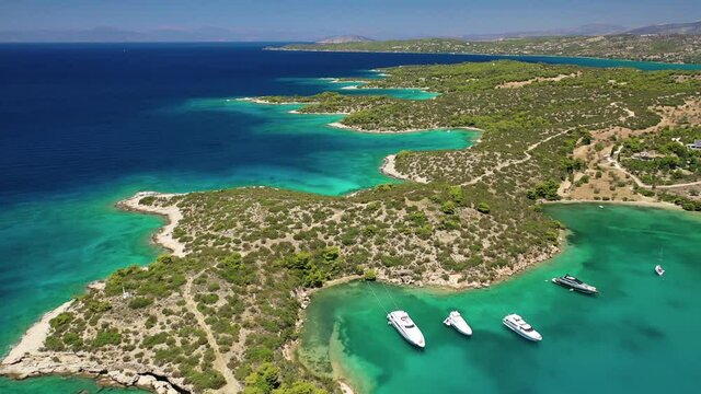 Aerial drone video of Hinitsa island bay a popular anchorage crystal clear turquoise sea bay for yachts and sailboats next to Porto Heli, Saronic gulf, Greece