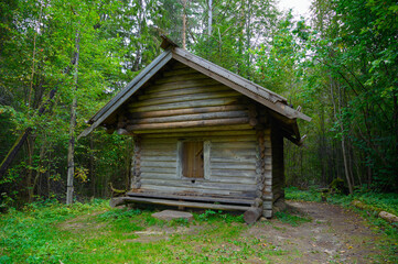 Ancient northern russian wooden cabins and churches in the wood near the river