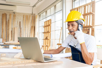 The elder or senior start their new career as a carpenter. Learn and search information online with computers. Talk to customers through mobile phones.