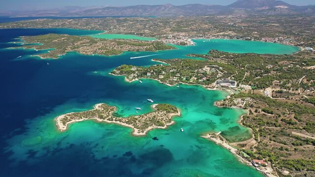 Aerial drone video of Hinitsa island bay a popular anchorage crystal clear turquoise sea bay for yachts and sailboats next to Porto Heli, Saronic gulf, Greece