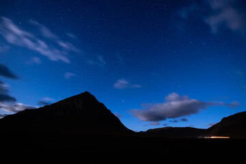 night shot of the stars and Milky Way above rannoch moor, glen etive and Glencoe in the argyll region of the highlands of Scotland during a clear bright night in autumn