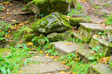 Fototapeta na wymiar stone steps of an ancient stairs covered with moss
