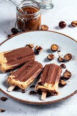 Chocolate ice cream with peanut cream on light background