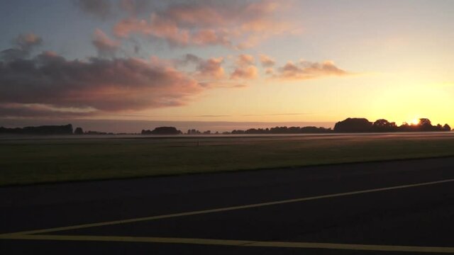 Pan from left to right of a little airport runway.