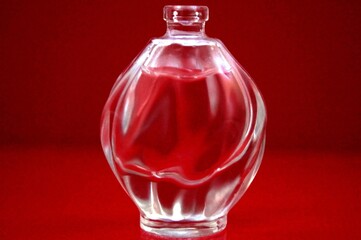 Perfume bottle on red background. 