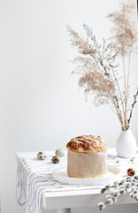 Easter yeast bread or cake with willow sprigs on the table. Easter concept