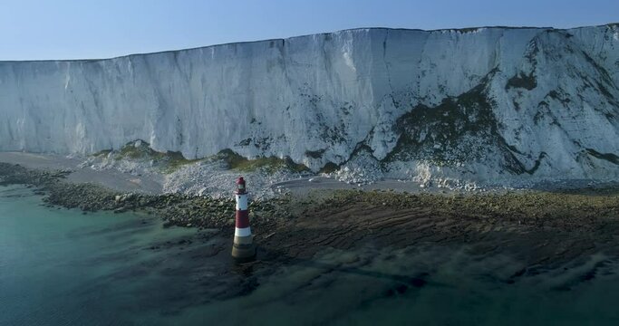 Aerial view of Beachy Head Lighthouse and the white chalk cliffs of the English south coast. This iconic landmark it Is located 14 mile south-east of Brighton and 4 miles south-west of Eastbourne