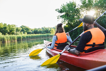 Loving couple kayaking on river