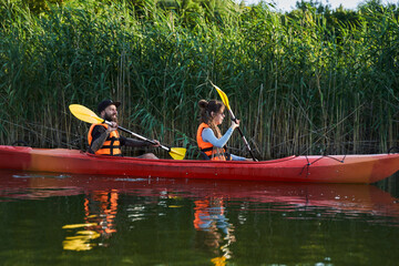 People on kayak outing rafting down the river