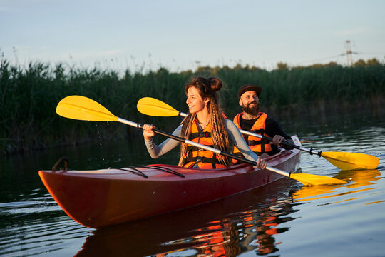 Young Couple Kayaking On River