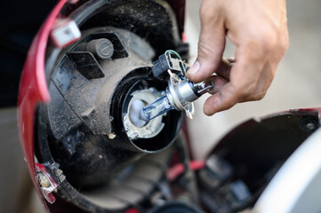 Fototapeta premium Motorcycle bulb replacement. holding a bulb with motorcycle.