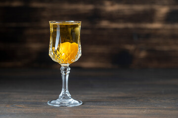 Homemade tincture of yellow cherry plum wine crystal glass on wooden background, Ukraine, close up