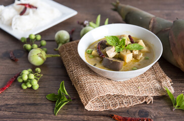 Chicken green curry with bamboo shoots and blood pudding (Kaeng kheiyw hwan) on dark wooden...
