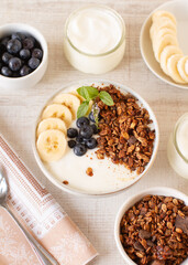 Homemade granola with blueberries and yoghurt on a table Healthy food, clean eating, dieting concept
