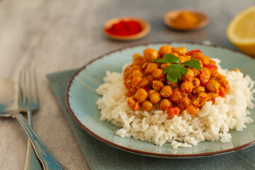 Homemade rustic chickpea curry with basmati rice on a table