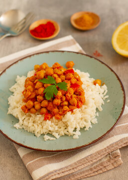 Homemade rustic chickpea curry with basmati rice on a table