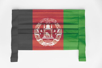 Face mask with Afghanistan flag printed, on white background